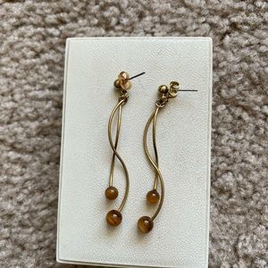 Brown and gold dangling earrings on posts